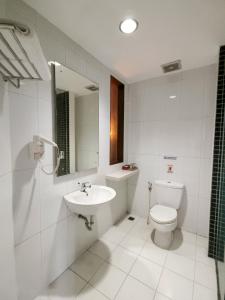 a white bathroom with a sink and a toilet at HOTEL TILAMAS in Dares