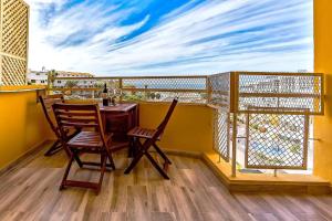 een balkon met een tafel en stoelen bij Orlando Jerry Ocean View Apartment in Adeje