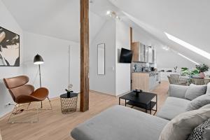 ein Wohnzimmer mit einem Sofa und einem Tisch in der Unterkunft Stilvolle Wohnung: Private Dachterrasse - zentral in Augsburg