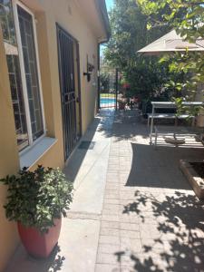 a porch with a plant in a pot next to a door at Esperance Guesthouse in Upington