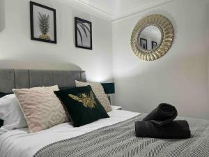 a bedroom with a bed with a mirror on the wall at Rose Court-Free Parking-Central-Long Stay Offer in Rochester