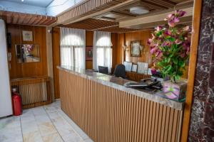 a lobby with a bar with a vase of flowers at Mekan Villa Otel in Selcuk
