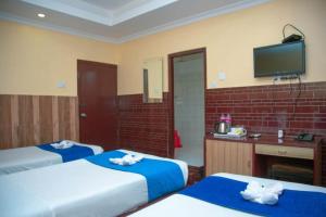 Postel nebo postele na pokoji v ubytování Taj Residency Pokhara