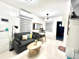 a living room with a couch and a table at Nyssa Crib 2BR Whole Townhouse Camella Bacolod South in Bacolod