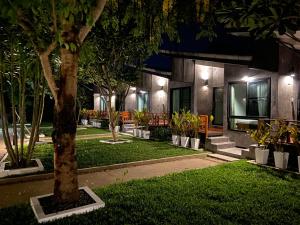 a building with trees and plants in front of it at Family House Zen Boutique Resort in Pai