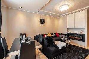 a living room with a couch and a table at LuxeCityApartment in Tallinn