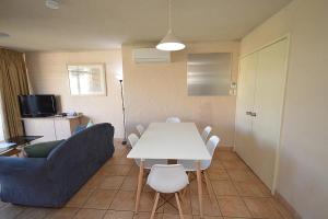a living room with a white table and a couch at Riverview Holiday Apartment 47 - Kalbarri, WA in Kalbarri