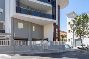 an apartment building with a balcony on a street at La Casa di Venere with parking in Bari