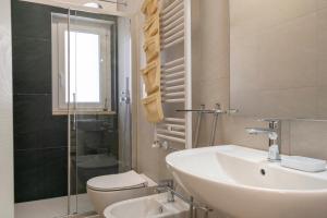 a bathroom with a sink and a toilet and a shower at La Casa di Venere with parking in Bari