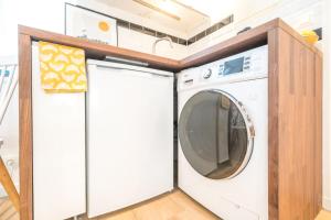 a washer and dryer in a kitchen with a counter at Happy Stay Paris - Cosy Studios - 5 min to Eiffel Tower in Paris