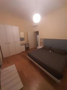 a bedroom with a black bed and a desk at Terra di Puglia in Mola di Bari