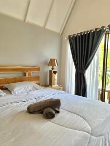 Postel nebo postele na pokoji v ubytování Vanilla Cottage Tetebatu