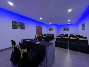 a room with black tables and chairs and blue ceilings at Once Upon The River, Aluva - Near Cochin International Airport in Cochin +57 photos