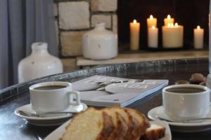 two cups of coffee and bread on a table with candles at THEARESORT EXCLUSIVE in Lygia +17 photos