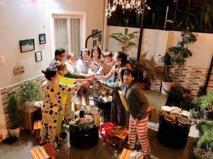 a group of people shaking hands in a room at Nhà của Ớt in Da Lat