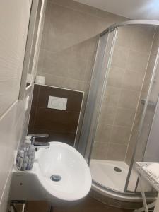 a small bathroom with a sink and a shower at Joel Living in Hannover