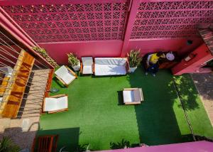een kamer met stoelen en roze muren bij La Casa Moz in Maputo