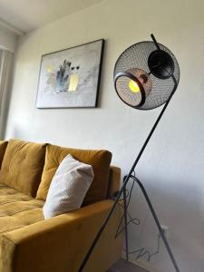 a lamp in a living room next to a couch at Zentrales Apartment am Theater in Marl in Marl