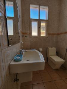 La salle de bains est pourvue d'un lavabo et de toilettes. dans l'établissement La Casa Moz, à Maputo