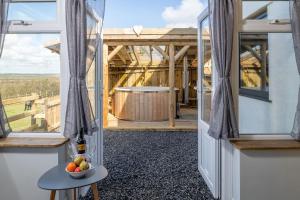 a room with a door and a bowl of fruit on a table at Willow Cottage in Gaerwen