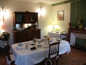 a dining room with a table with a white table cloth at Chambres d'hôtes -B&B- La Bonneterie in Montaigut-le-Blanc
