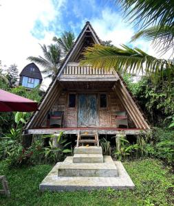 a small house with stairs leading up to it at Jero Tumbuk Private Villa in Selat