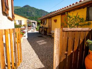 a wooden fence in front of a house at Maison de vacances in Bompas