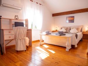 a bedroom with a bed and a desk at Maison de vacances in Bompas