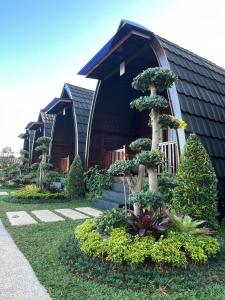 a house with a bonsai tree in front of it at Munduk Kupang Sekumpul Villa in Singaraja