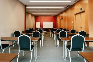 an empty classroom with desks and chairs and a whiteboard at AS Porta de Barcelona in Castellbisbal