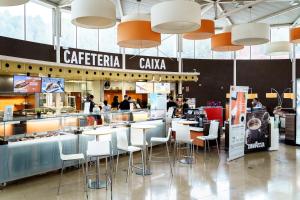 a restaurant with tables and chairs in a mall at AS Porta de Barcelona in Castellbisbal