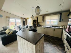 a large kitchen with a large island in a room at Bella Rose Lodge with Hot Tub in Malton