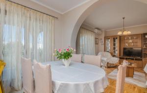 a dining room with a white table and chairs at Marina Porat in Porat