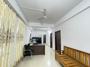 a hallway with a bench and a desk in a room at Alub Naam Homestay in Itānagar