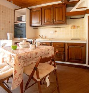 a kitchen with a table with a bowl on it at Alta Luce Mountain Lodge in Gressoney-la-Trinité