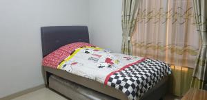 A bed or beds in a room at Kumara Homestay Jogja