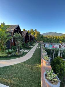 a row of cottages with plants inront of them at Munduk Kupang Sekumpul Villa in Singaraja