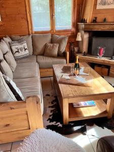 a living room with a couch and a coffee table at Chalet Le Lauzet in Les Deux Alpes