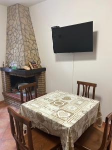 a dining room with a table and a fireplace at HAPPY HOME in Orte