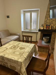 a living room with a table and a fireplace at HAPPY HOME in Orte