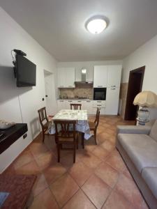 a living room with a table and a couch at HAPPY HOME in Orte