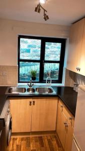 a kitchen with a sink and a window at Cosy flat close to city centre. in Nether Edge