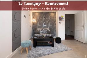 a living room with a sofa bed and table at Le Tassigny - Hyper-Centre Balneo in Remiremont