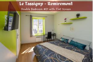 a bedroom with a bed and a flat screen tv at Le Tassigny 3 étoiles - Hyper-Centre Balneo Wifi Parking in Remiremont +14 photos