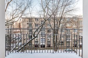 a gate in front of a building in the snow at Apartament One by Your Freedom in Warsaw