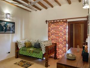 a living room with a couch and a table at Paka House-Rafiki Village in Watamu