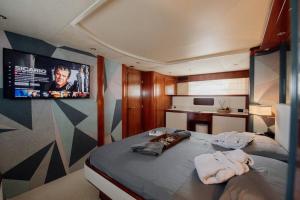 a bedroom with a bed with two towels on it at Beyond82: Luxury Yacht in Puglia in Brindisi