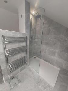a shower with a glass door in a bathroom at Stony Stratford Private Cosy Home in Stony Stratford