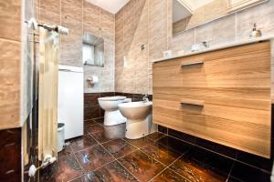 a bathroom with a toilet and a sink at Atlantis Inn Castelgandolfo in Castel Gandolfo