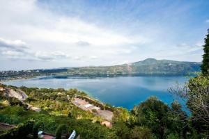 a view of a lake with mountains in the background at Atlantis Inn Castelgandolfo in Castel Gandolfo